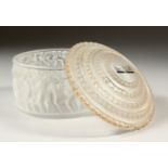 A LALIQUE CIRCULAR FROSTED PIN BOX AND COVER, the sides with a band of moulded figures of cupids,