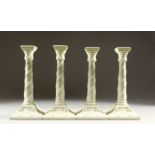 A SET OF FOUR WORCESTER STYLE BLANC DE CHINE GLAZED CANDLESTICKS, of classical design. 27cms high.