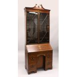 AN UNUSUAL GEORGE III MAHOGANY AND MARQUETRY BUREAU BOOKCASE, with broken arch pediment, pair of