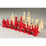 A RED AND WHITE STAINED IVORY CHESS SET.