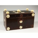 AN INDIAN LACQUER BOX, mounted with ivory finials and pierced roundels. 28cms wide.