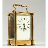A SMALL BRASS CARRIAGE CLOCK, the case with column corners, white enamel dial and Roman numerals.