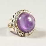 A SILVER AND AMETHYST RING.