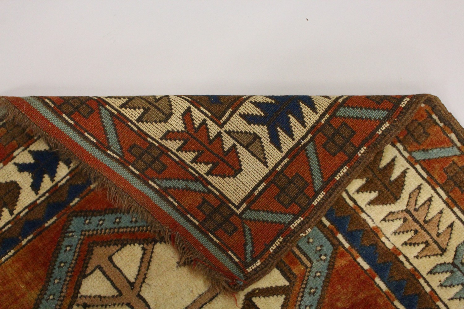 A SMALL PERSIAN RUG, the centre with two large geometric motifs, in a border with stylised tree - Image 7 of 8