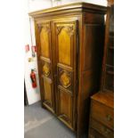 A 19TH CENTURY FRENCH WALNUT TWO DOOR ARMOIRE, with moulded cornice, a pair of carved, panelled