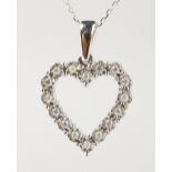 A 9CT GOLD AND DIAMOND SET HEART SHAPED PENDANT AND CHAIN.