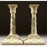 A PAIR OF ROYAL WORCESTER CREAM WARE CANDLESTICKS. Pattern No. 1050. 21cms high.