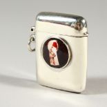 A SMALL SILVER VESTA CASE, with later enamel decoration. 4cms high.
