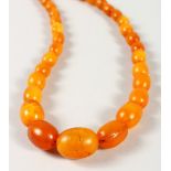 A STRING OF AMBER BEADS.