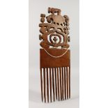 A GOOD LARGE CARVED WOOD TRIBAL COMB carved with a bison and an elephant. 39cms long x 13cms wide.