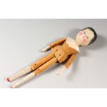 A PRIMITIVE PAINTED WOODEN TOY DOLL. 28cms long.