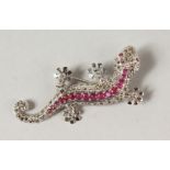 A SILVER RUBY SET LIZARD BROOCH.