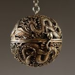 A CHINESE SILVER PIERCED DRAGON BALL CENSER. 5.5cms diameter.