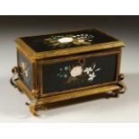 A 19TH CENTURY BRASS AND PIETRA DURA CASKET, inlaid with floral panels on scroll feet. 18cms wide