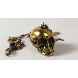A BRASS SKULL WATCH CHAIN AND SNUFF BOX.