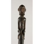 AN EARLY AFRICAN WOODEN STAFF WITH FIGURE HANDLE. 50cms long.