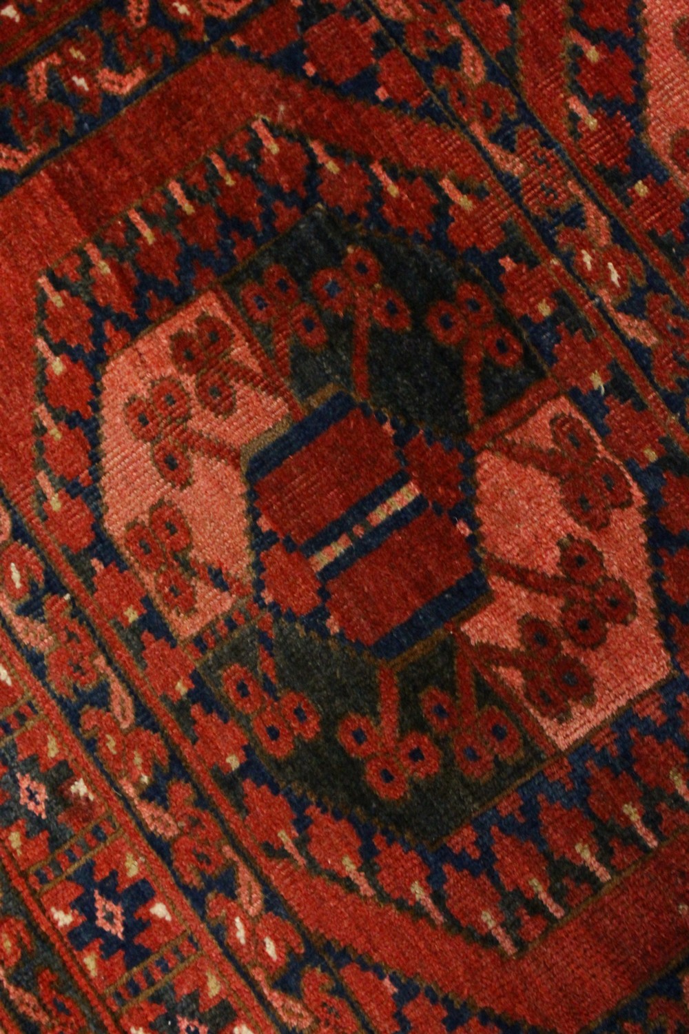 A SMALL PERSIAN RUG, rust ground with two large motifs. 106cms x 100cms. - Image 4 of 6