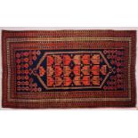 A PERSIAN RUG, dark blue ground, geometric motifs in a multiple border. 195cms x 110cms.