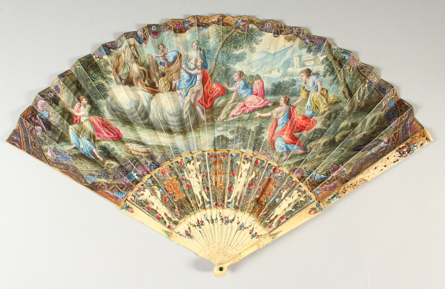 A LOUIS XVTH CARVED AND PAINTED IVORY FAN painted with classical scenes. Provenance: J. DUVELLEROY