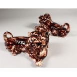 A GOOD PAIR OF GLAZED RECUMBENT LIONS. 20cms long.