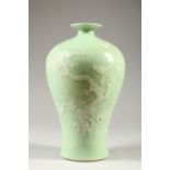A CHINESE CELADON GLAZE MEIPING STYLE VASE, decorated with a prunus tree. 27.5cms high.