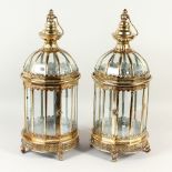 A PAIR OF ORNATE SILVER COLOURED HANGING LANTERNS. 61cms high.