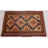 A GOOD SMALL PERSIAN RUG, cream ground with stylized bird and animal motifs. 182cms x 115cms.