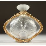 A GOOD SMALL LALIQUE FROSTED GLASS SCENT BOTTLE, the sides with moulded heads and rose on the