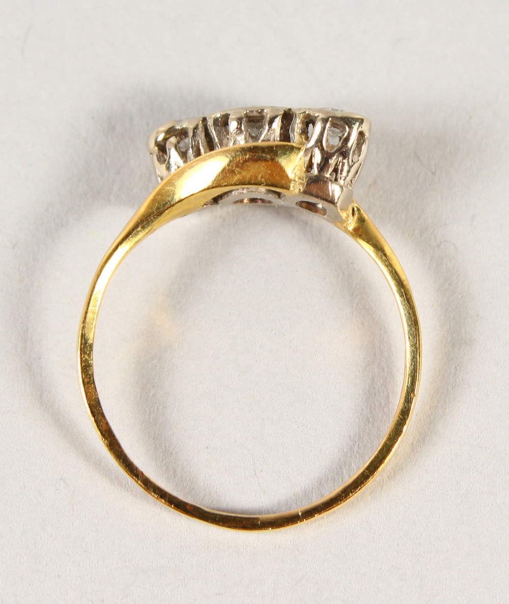 AN 18CT GOLD THREE STONE DIAMOND CROSSOVER RING. - Image 2 of 3