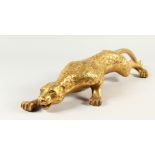 A POLISHED BRASS MODEL OF A STALKING PANTHER. 65cms long.