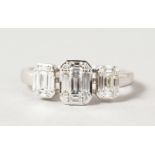 AN 18CT WHITE GOLD THREE STONE DIAMOND SET RING.