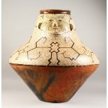 A VERY GOOD LARGE PERUVIAN SHIPIBO CULTURE CIRCULAR POT, the side with a face. 59cms high x 59cms