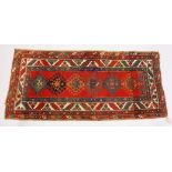 A PERSIAN RUG, red ground with six medallions, in a quadruple border. 200cms x 96cms.