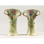 A PAIR OF MOORCROFT MACINTYRE TWO-HANDLED VASES, CIRCA. 1907, painted with sprays of roses, tulips
