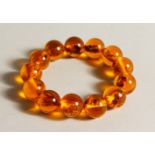 AN AMBER STYLE BEAD BRACELET. 22cms long.