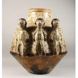 A GOOD LARGE PERUVIAN SHIPIBO CULTURE CIRCULAR POT, with three figures on the side. 56cms high x