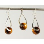 A SILVER AND TIGER'S EYE EARRINGS AND PENDANT SET.
