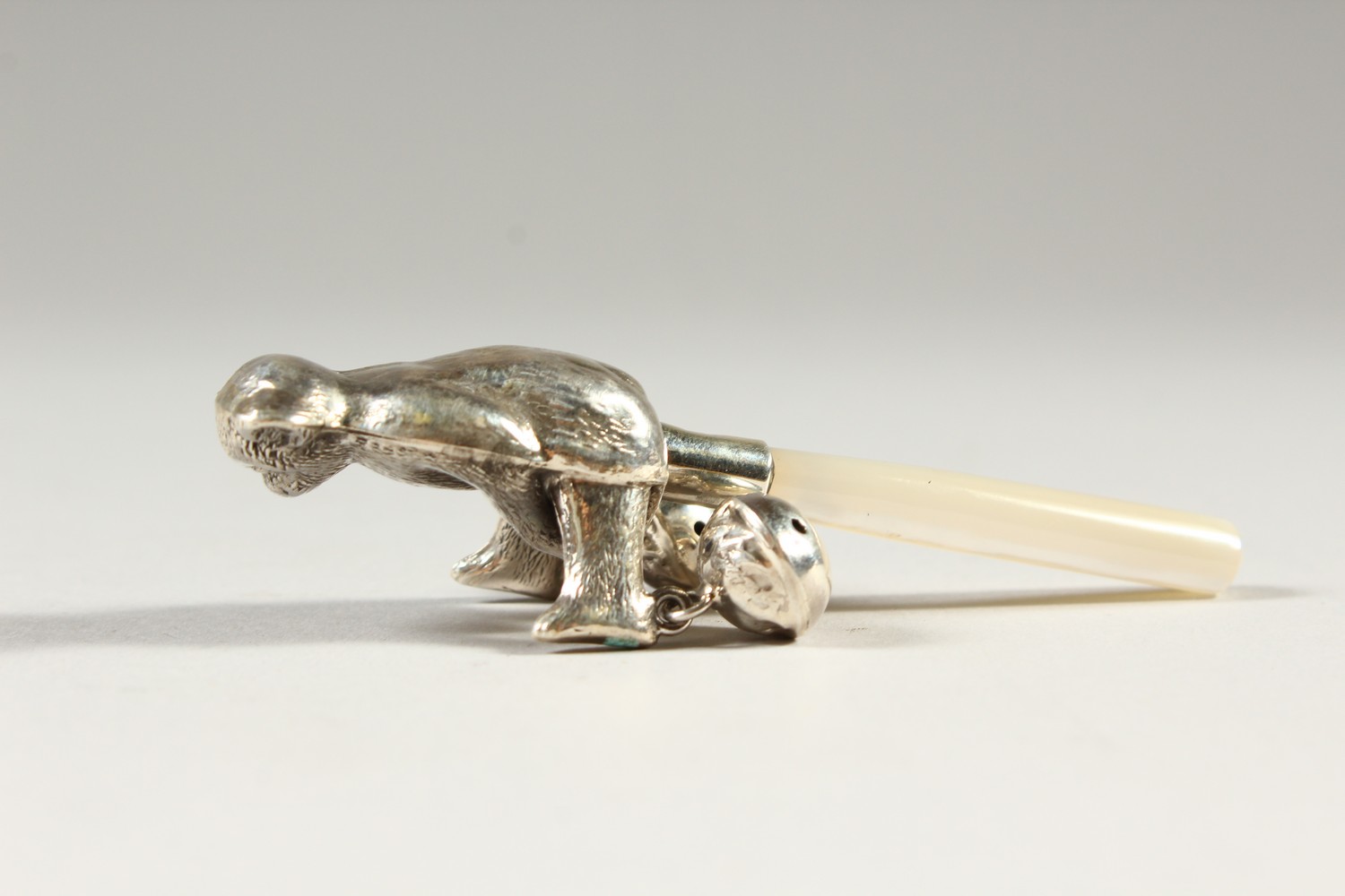 A SILVER TEDDY BEAR RATTLE, with mother-of-pearl handle. 9.5cms long. - Image 2 of 2