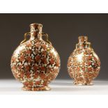A PAIR OF PILGRIM BOTTLES with small gilt handles decorated with flowers in red and brown. 23cms