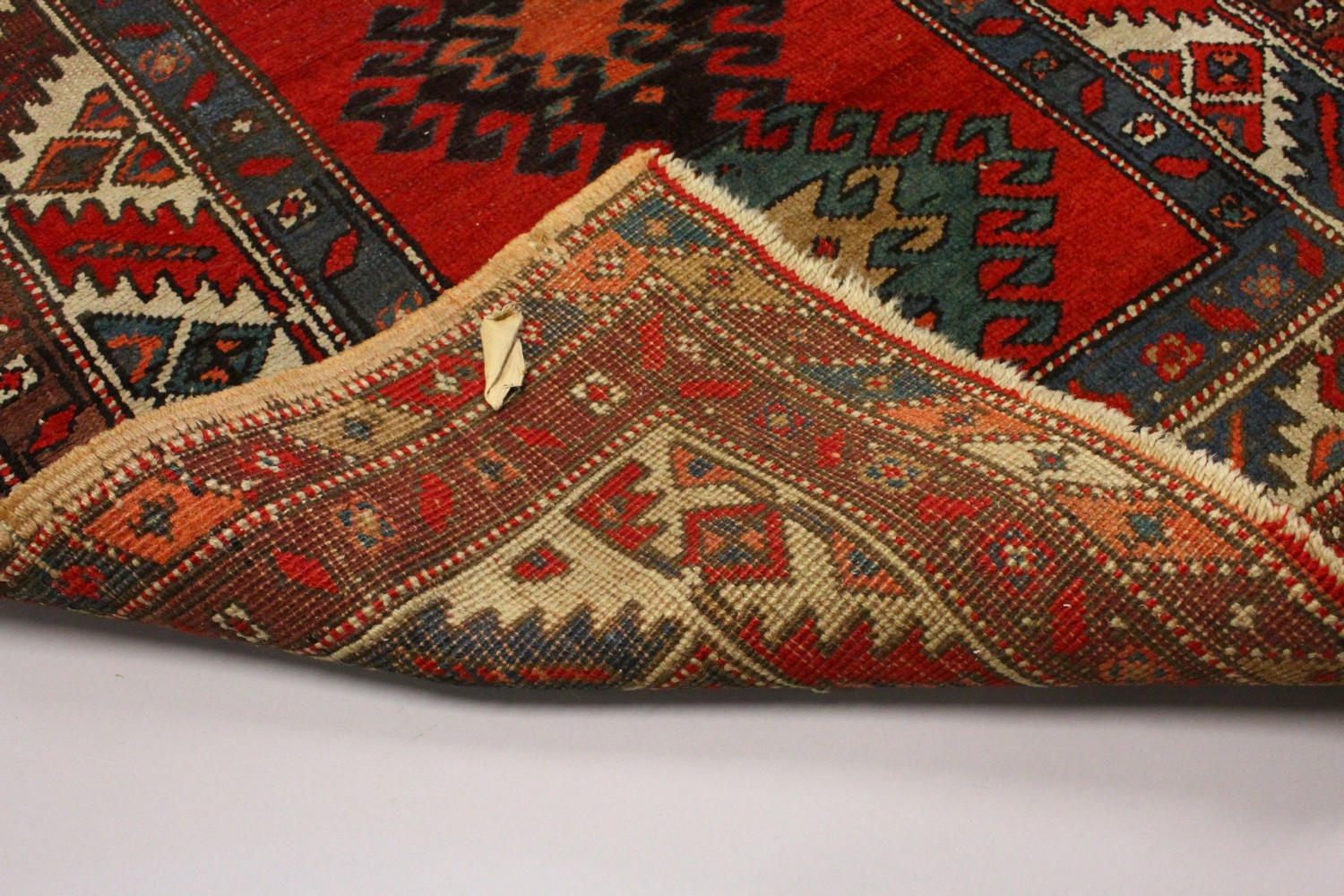 A PERSIAN RUG, red ground with six medallions, in a quadruple border. 200cms x 96cms. - Image 7 of 8