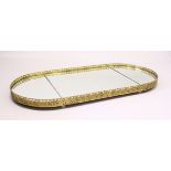 A LARGE GILT METAL MIRRORED PLATEAU / STAND, of oval form with three bevelled mirror plates and a
