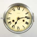 AN EARLY 20TH CENTURY NICKEL PLATED CIRCULAR WALL CLOCK, chiming on the hour, cream enamel dial with