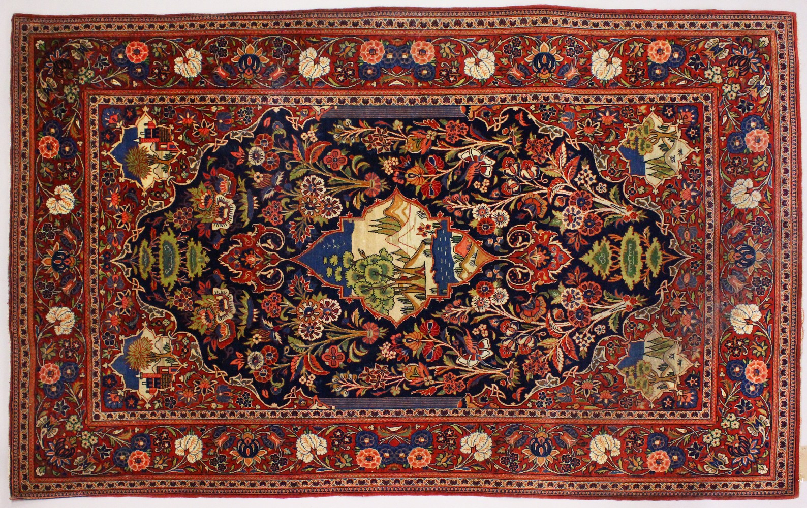 A GOOD PERSIAN "TREEOF LIFE" RUG decorated with panels of buildings and landscapes within a floral