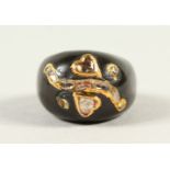 AN UNUSUAL BLACK ONYX RING SET WITH DIAMONDS.