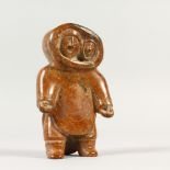 A SERPENTINE CARVING OF AN ESKIMO. 13cms long.