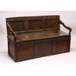 A 17TH / 18TH CENTURY OAK SETTLE, with carved cresting rail, triple panel back, downswept arms,