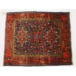 A GOOD SMALL PERSIAN RUG, dark blue ground with three stylised motifs in a similar border. 140cms