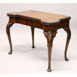 A GEORGE II STYLE WALNUT FOLD-OVER CARD TABLE, of shaped outline, the folding top revealing a