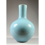 A CHINESE PALE BLUE BOTTLE VASE. 33cms high.