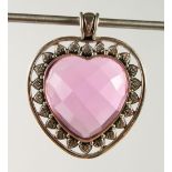 A SILVER AND PINK STONE HEART SHAPE PENDANT.